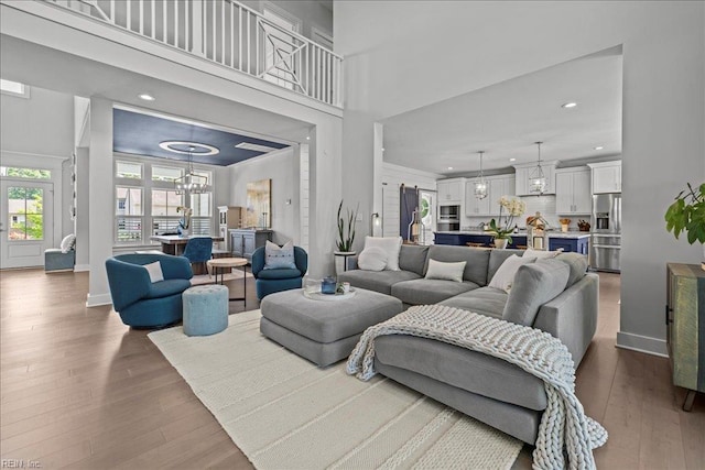 909 Los Colonis Dr, Virginia Beach, VA 23456 - living area featuring wood finished floors, recessed lighting, a chandelier, baseboards, and a high ceiling