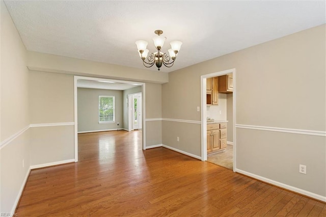 18 Welcome Way, Hampton, VA 23666 - empty room with a chandelier, light wood finished floors, and baseboards