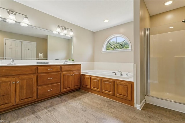 18 Welcome Way, Hampton, VA 23666 - full bathroom featuring wood finished floors, double vanity, a garden tub, and a shower with door