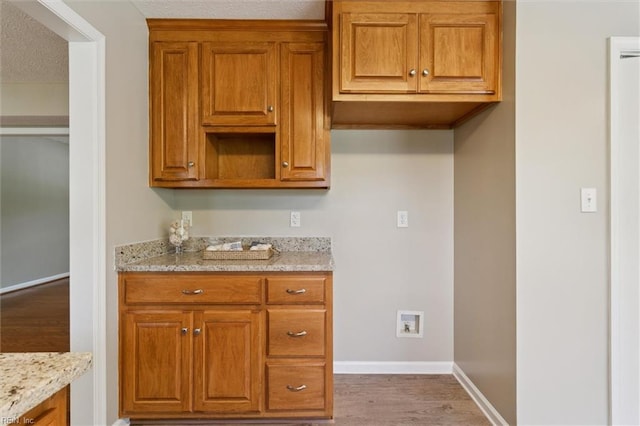 18 Welcome Way, Hampton, VA 23666 - kitchen with baseboards, wood finished floors, brown cabinetry, and light stone countertops
