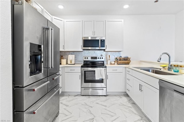 1733 Dromolin St Unit 205, Virginia Beach, VA 23456 - kitchen featuring appliances with stainless steel finishes, a sink, light marble finish flooring, recessed lighting, and white cabinetry