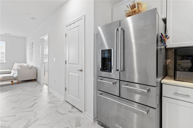 1733 Dromolin St Unit 205, Virginia Beach, VA 23456 - kitchen with high end refrigerator, light marble finish flooring, white cabinets, open floor plan, and baseboards