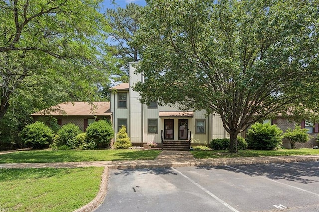 50 James Sq, Williamsburg, VA 23185 - view of front of house with uncovered parking and a front lawn
