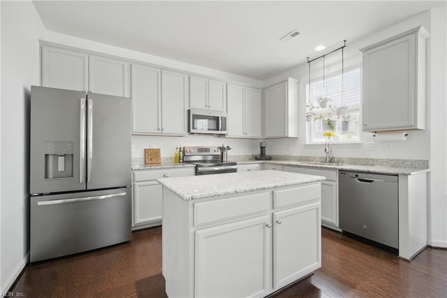 637 Wood Nymph Ln, Chesapeake, VA 23323 - kitchen with stainless steel appliances, a sink, dark wood-style flooring, and a kitchen island