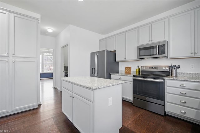 637 Wood Nymph Ln, Chesapeake, VA 23323 - kitchen featuring stainless steel appliances, dark wood finished floors, a kitchen island, light stone countertops, and white cabinets