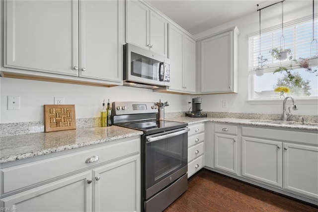 637 Wood Nymph Ln, Chesapeake, VA 23323 - kitchen featuring appliances with stainless steel finishes, a sink, dark wood-style flooring, and light stone counters