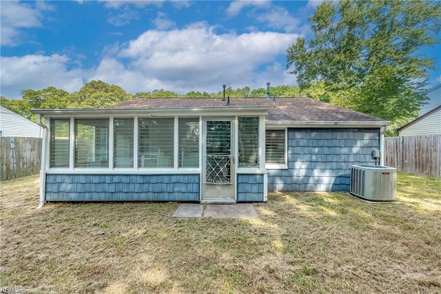 423 Cedar Dr, Hampton, VA 23669 - back of property with central AC unit, a sunroom, and roof with shingles