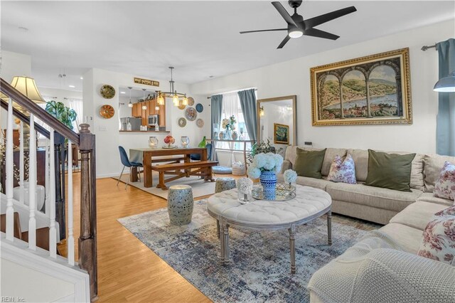 245 Feldspar St, Virginia Beach, VA 23462 - living area with stairway, a ceiling fan, light wood-style flooring, and a chandelier