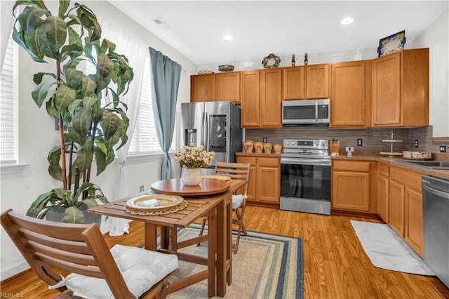 245 Feldspar St, Virginia Beach, VA 23462 - kitchen featuring appliances with stainless steel finishes, plenty of natural light, tasteful backsplash, light wood-style floors, and recessed lighting