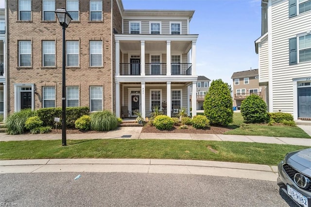 245 Feldspar St, Virginia Beach, VA 23462 - townhome / multi-family property with a balcony, brick siding, and covered porch