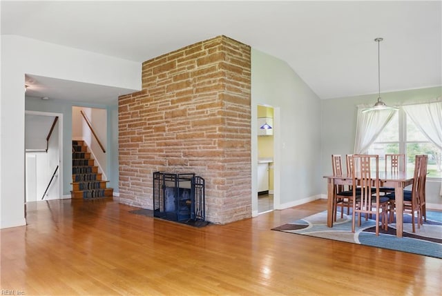 5013 Leslie Dr, Portsmouth, VA 23703 - dining area with lofted ceiling, wood finished floors, stairs, baseboards, and a fireplace