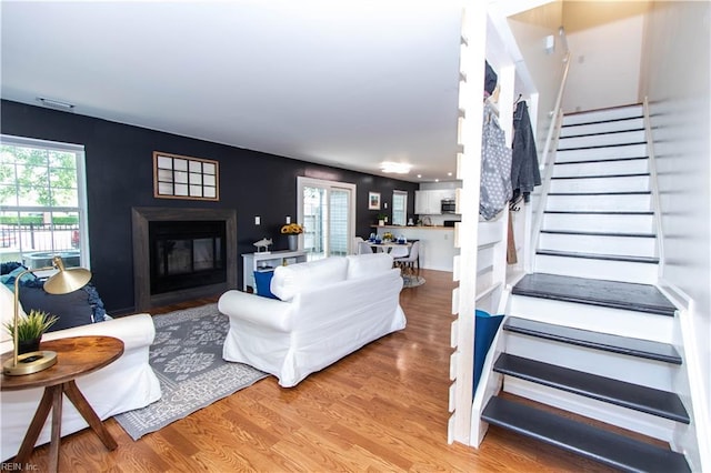 4510 Indies Ct, Virginia Beach, VA 23462 - living area featuring stairway, a glass covered fireplace, and wood finished floors