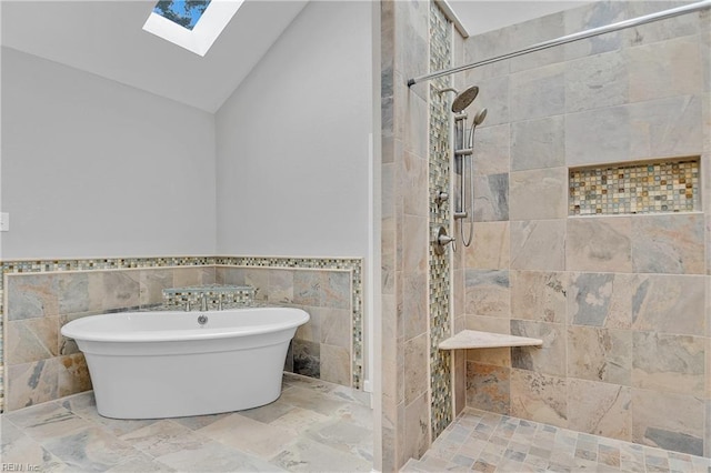 808 High Point Ave, Virginia Beach, VA 23451 - bathroom featuring a skylight, a freestanding bath, high vaulted ceiling, tiled shower, and tile walls