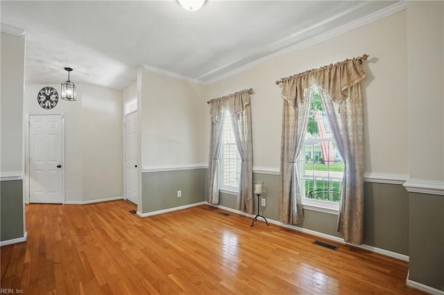 6772 Burbage Lake Cir, Suffolk, VA 23435 - unfurnished room featuring light wood-type flooring, a chandelier, baseboards, and crown molding