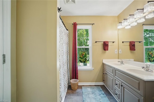 6772 Burbage Lake Cir, Suffolk, VA 23435 - full bathroom with double vanity, plenty of natural light, and baseboards