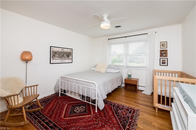 2522 Jasper Ct, Norfolk, VA 23518 - bedroom with a baseboard heating unit, wood finished floors, and ceiling fan