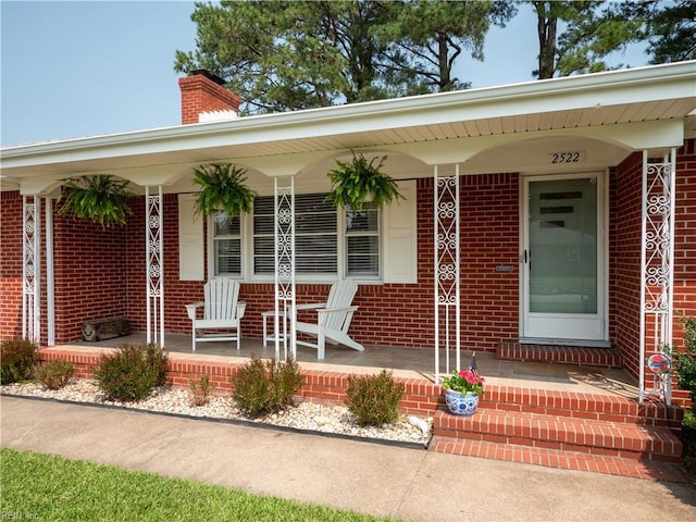 2522 Jasper Ct, Norfolk, VA 23518 - view of exterior entry featuring covered porch, brick siding, and a chimney