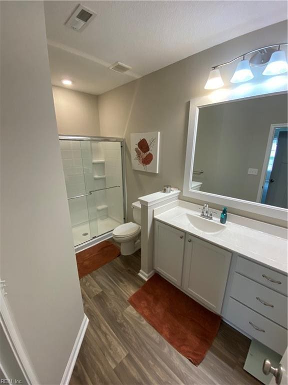 1010 Kings Land Ct, Williamsburg, VA 23185 - bathroom with wood finished floors, a shower stall, and vanity