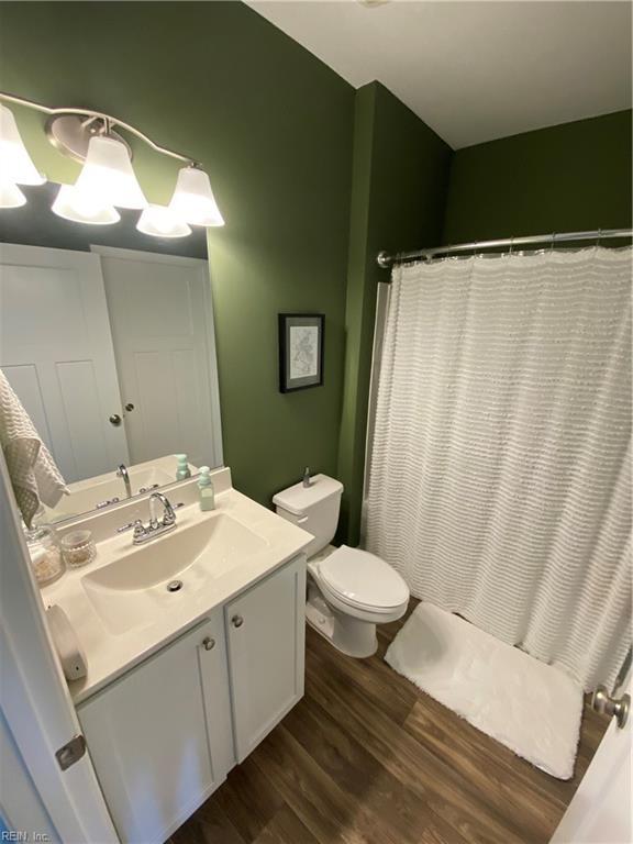1010 Kings Land Ct, Williamsburg, VA 23185 - bathroom featuring vanity, wood finished floors, and a shower with curtain