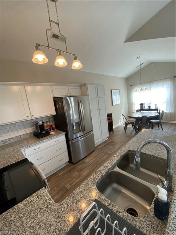 1010 Kings Land Ct, Williamsburg, VA 23185 - kitchen featuring stainless steel fridge, white cabinetry, vaulted ceiling, tasteful backsplash, and decorative light fixtures