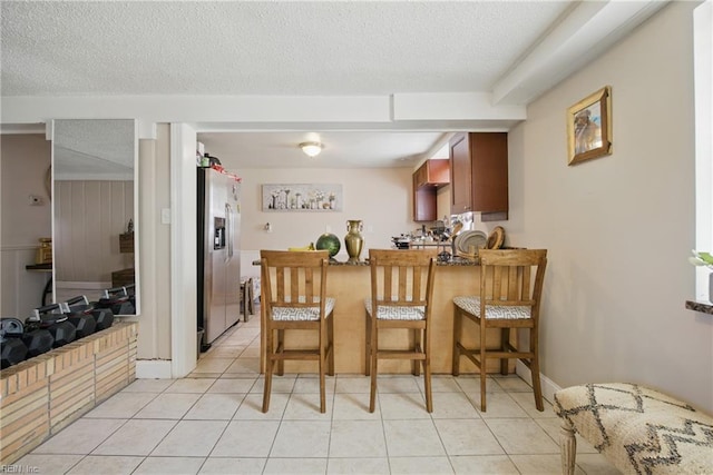 5133 E Princess Anne Rd, Norfolk, VA 23502 - kitchen with stainless steel fridge, light tile patterned floors, a textured ceiling, and a peninsula