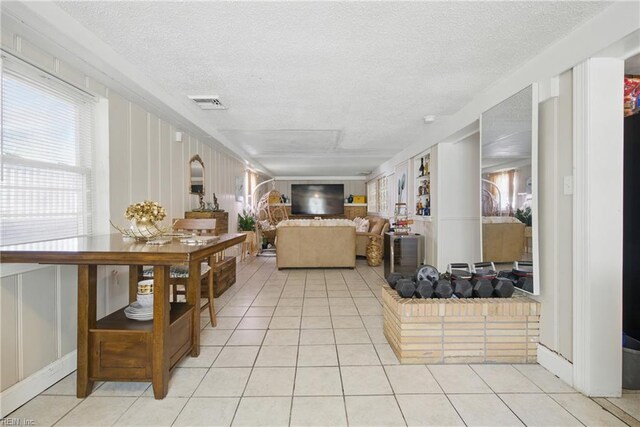 5133 E Princess Anne Rd, Norfolk, VA 23502 - living area featuring light tile patterned floors and a textured ceiling