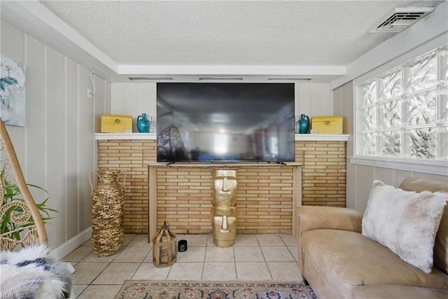 5133 E Princess Anne Rd, Norfolk, VA 23502 - tiled living room featuring a textured ceiling and brick wall