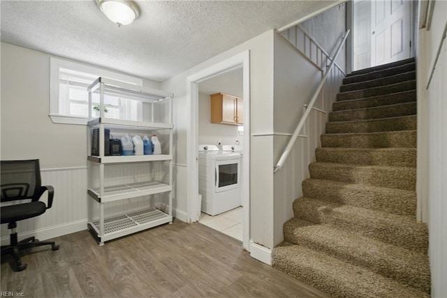 5133 E Princess Anne Rd, Norfolk, VA 23502 - staircase with washing machine and dryer, wood finished floors, a textured ceiling, and wainscoting
