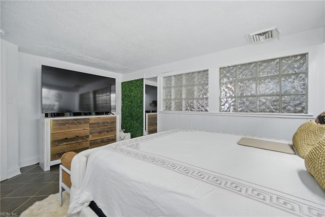 5133 E Princess Anne Rd, Norfolk, VA 23502 - tiled bedroom featuring a textured ceiling and baseboards