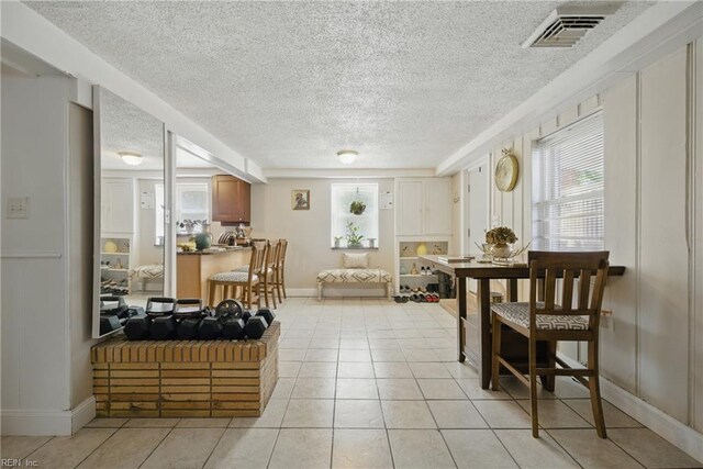5133 E Princess Anne Rd, Norfolk, VA 23502 - dining area with a textured ceiling, healthy amount of natural light, light tile patterned floors, and baseboards