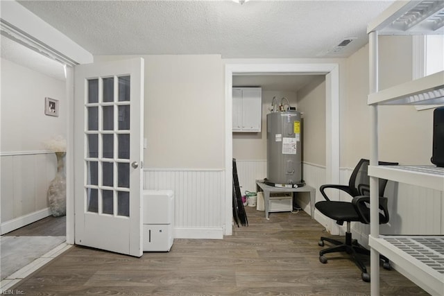 5133 E Princess Anne Rd, Norfolk, VA 23502 - home office featuring electric water heater, wood finished floors, wainscoting, and a textured ceiling