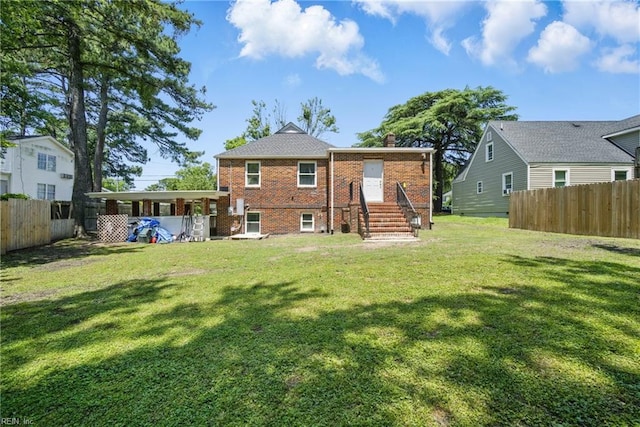 5133 E Princess Anne Rd, Norfolk, VA 23502 - rear view of property with a chimney, brick siding, a carport, and entry steps
