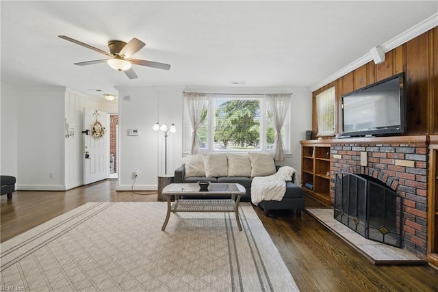 5133 E Princess Anne Rd, Norfolk, VA 23502 - living area with dark wood-type flooring, ceiling fan, crown molding, baseboards, and a brick fireplace