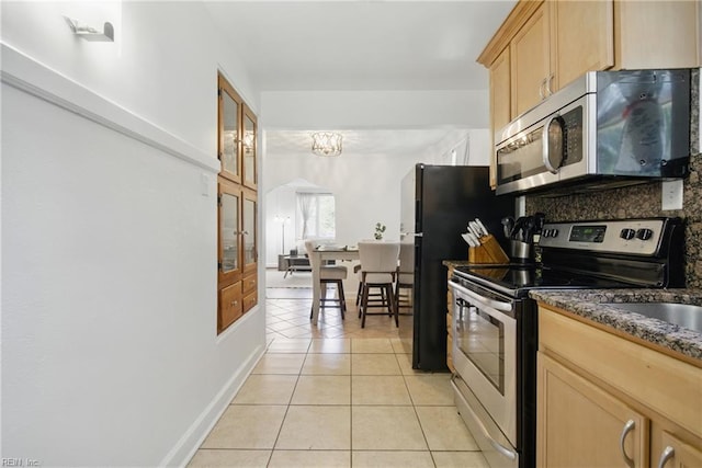 5133 E Princess Anne Rd, Norfolk, VA 23502 - kitchen featuring appliances with stainless steel finishes, light tile patterned flooring, light brown cabinetry, backsplash, and dark stone countertops