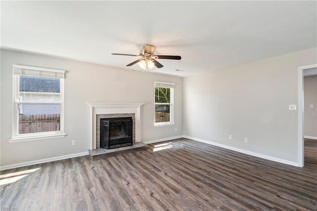 230 Abingdon Cir, Suffolk, VA 23434 - unfurnished living room with dark wood-style floors, ceiling fan, a brick fireplace, and baseboards