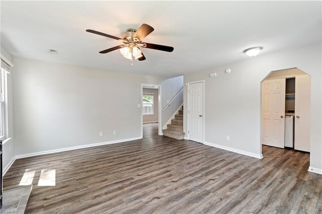 230 Abingdon Cir, Suffolk, VA 23434 - spare room with a ceiling fan, dark wood-style floors, baseboards, stairs, and arched walkways