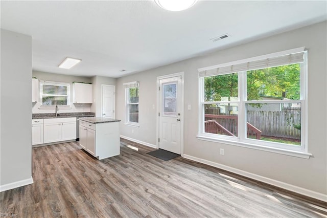 230 Abingdon Cir, Suffolk, VA 23434 - kitchen featuring a sink, a kitchen island, baseboards, white cabinets, and wood finished floors