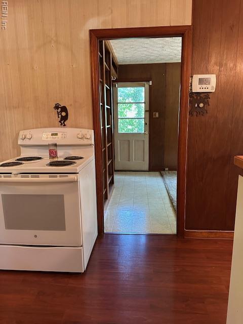 5216 Hemlock Rd, Quinton, VA 23141 - kitchen featuring electric stove, wood walls, and wood finished floors