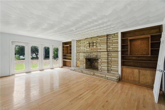 3555 Heutte Dr, Norfolk, VA 23518 - unfurnished living room featuring built in features, wood finished floors, and a fireplace