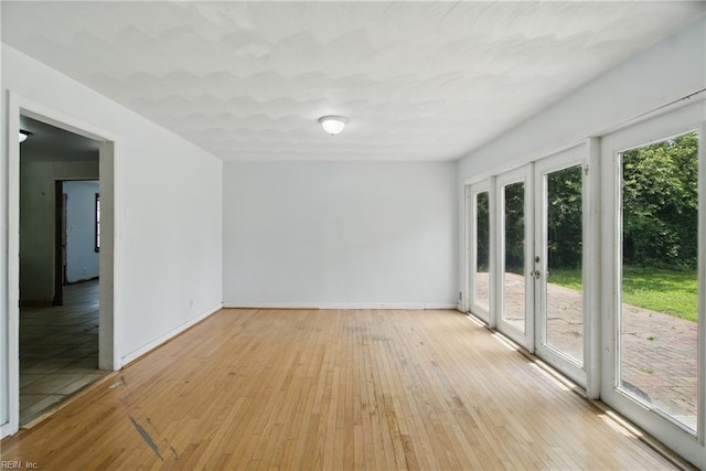 3555 Heutte Dr, Norfolk, VA 23518 - unfurnished room featuring plenty of natural light, light wood-style floors, and baseboards