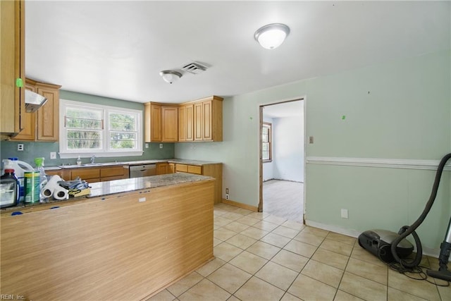 3555 Heutte Dr, Norfolk, VA 23518 - kitchen with light tile patterned floors, baseboards, stainless steel dishwasher, a sink, and a peninsula