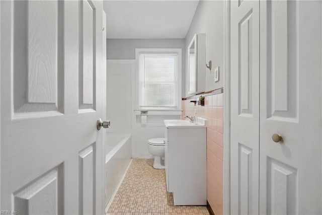 3555 Heutte Dr, Norfolk, VA 23518 - bathroom featuring vanity, toilet, and washtub / shower combination