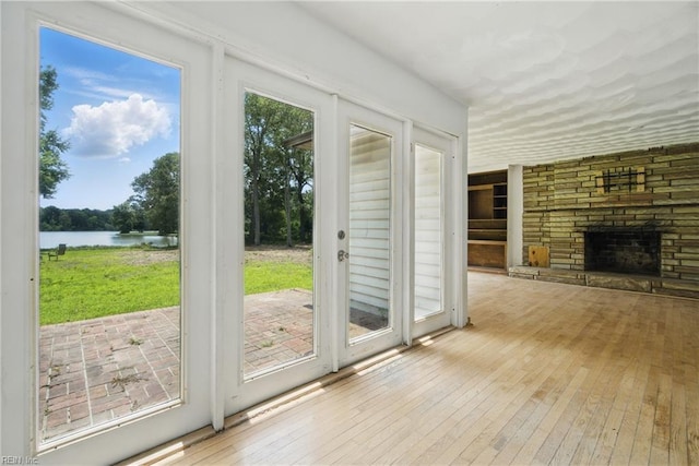 3555 Heutte Dr, Norfolk, VA 23518 - doorway to outside featuring a water view, hardwood / wood-style floors, and a fireplace with raised hearth