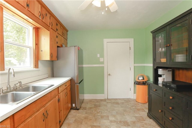 327 Brightwood Ave, Hampton, VA 23661 - kitchen with a sink, freestanding refrigerator, a ceiling fan, light countertops, and brown cabinetry