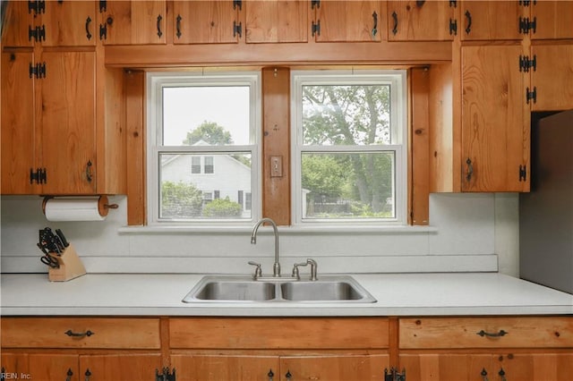 327 Brightwood Ave, Hampton, VA 23661 - kitchen featuring a sink, light countertops, and brown cabinetry
