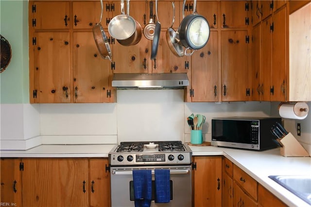 327 Brightwood Ave, Hampton, VA 23661 - kitchen featuring stainless steel appliances, under cabinet range hood, light countertops, and brown cabinets