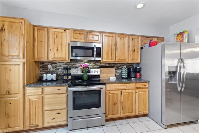 560 Davis St, Virginia Beach, VA 23462 - kitchen with stainless steel appliances, decorative backsplash, light tile patterned flooring, recessed lighting, and dark stone counters