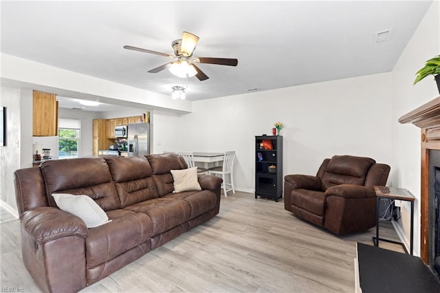 560 Davis St, Virginia Beach, VA 23462 - living room with a ceiling fan, light wood-style floors, a fireplace, and baseboards