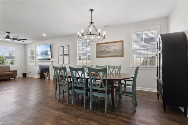 1906 Briton Ln, Chesapeake, VA 23322 - dining area featuring dark wood-style flooring, plenty of natural light, a chandelier, a lit fireplace, and recessed lighting