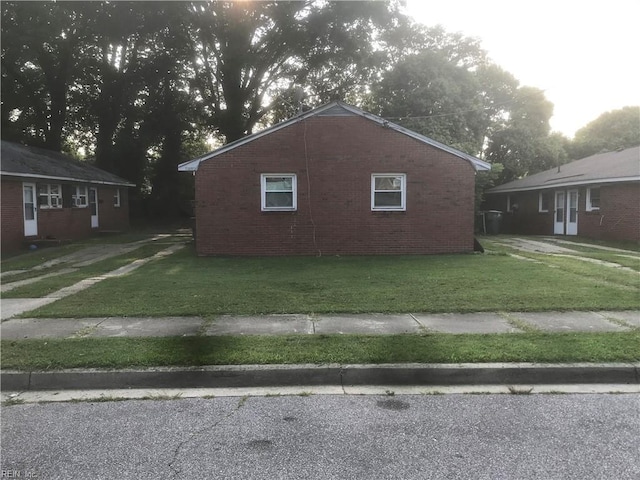 3227 Vimy Ridge Ave, Norfolk, VA 23509 - view of side of home with a lawn and brick siding